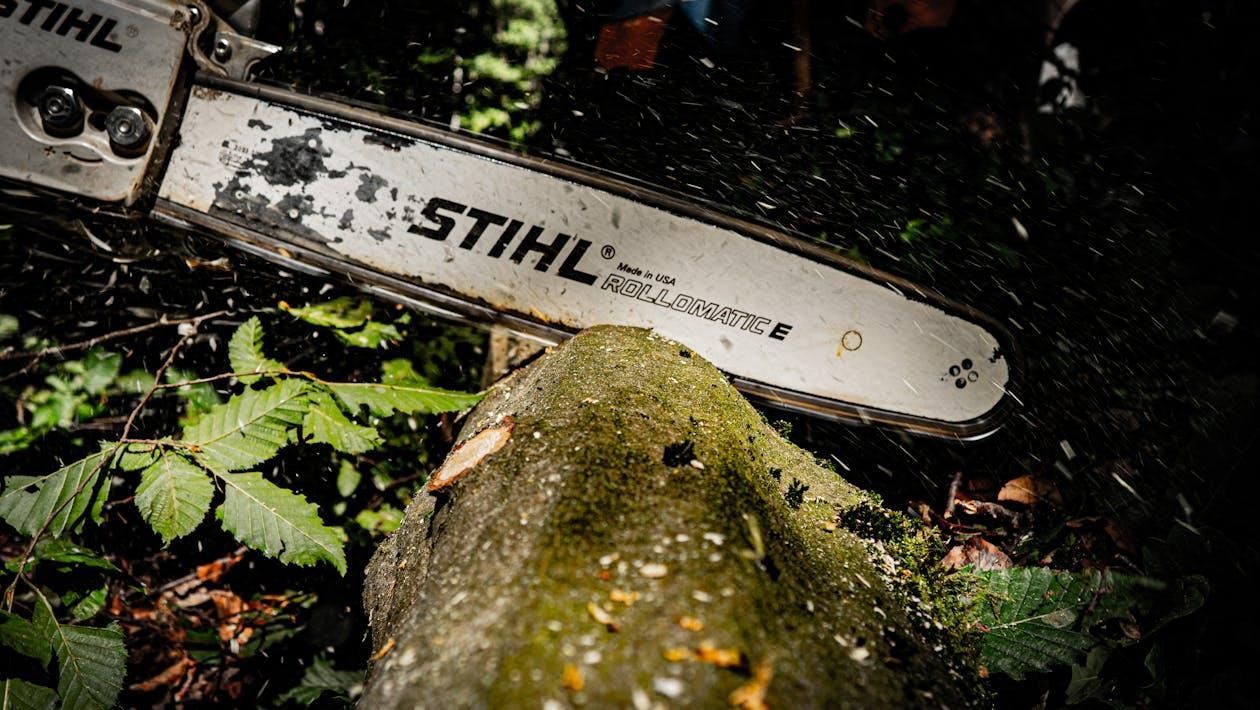 A Stihl Rollomatic E cutting down a tree.